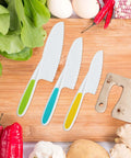 8-piece kids kitchen knife set on wooden board; white blades with green, blue and yellow handles