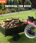 Heavy Duty ATV Trailer Steel Dump Cart 750 lb Capacity 15 cu ft attached to lawn tractor with firewood in garden