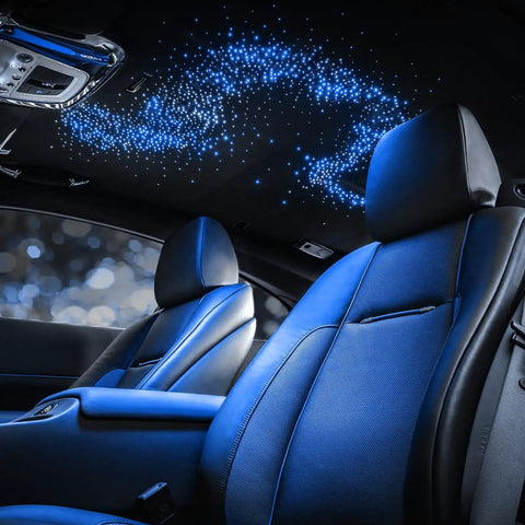 Interior of a car with Starlight Headliner Kit With 300 Fiber Optic Strands, 9.8 Ft Length, RGBW Color Changing Lights on roof.