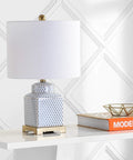 21.5 Inch White And Navy Ceramic Ginger Jar LED Table Lamp With Fishnet Chinoiserie Pattern on a modern shelf