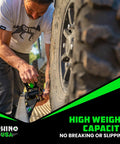 Man securing tire with Beefy Heavy Duty Self Retracting Ratchet Straps 2 Inch By 10 Feet With 3033 Pound Break Strength for truck