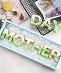 Alphabet Letter Cookie Cutter Set 26 Pcs Large 3 Inch Stainless Steel Bakeware For Fondant Biscuits Dough Molds For Birthday Parties Christmas Holidays And New Year Decorations shown with cookies spelling 'MOTHER' and 'DAY'