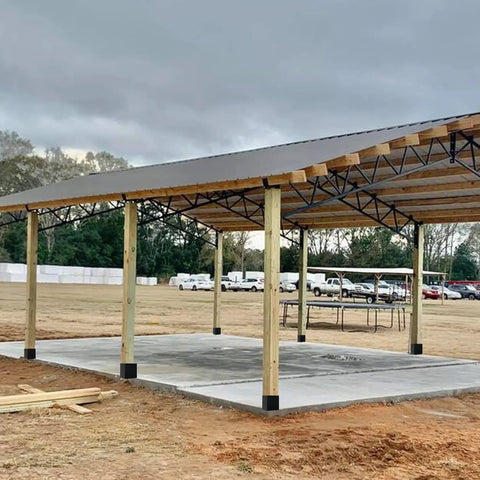 Outdoor pavilion with Sturdy 4x4 Post Base Anchor Ground Spike for Concrete Decks and Fence Posts, Black Powder Coated Steel support.