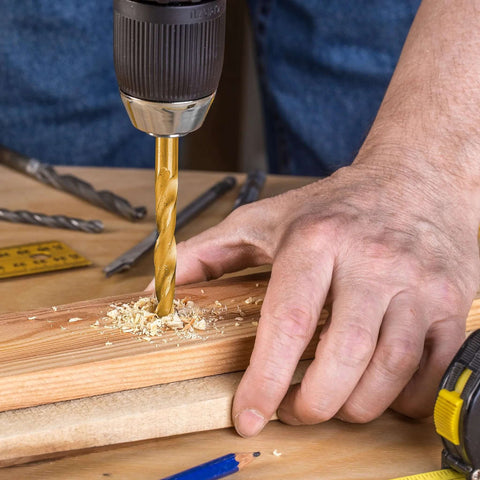 Cobalt left-hand drill bit, TiN-coated gold bit drilling into wood