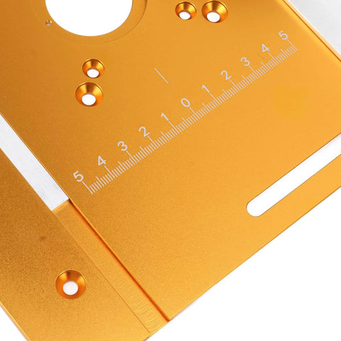 Orange aluminum router table insert plate, close-up view with ruler scale and mounting holes.