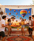 Friends enjoying a party in front of a 7x5ft Hot Air Balloon Backdrop With Colorful Rainbow Sky And Mountain Scene For Birthday Parties