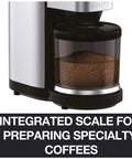 Hella Precise Automatic Coffee Grinder With Built In Scale And Thirty Nine Custom Settings For Bang Perfect Home Brews Solid Daily Ritual With Fourteen Oz Bean Hopper Sleek Black Design close up of integrated scale and coffee grounds in hopper.