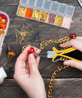 Person using pliers from 8-Piece Jewelry Pliers Kit With Storage Bag For Beading And DIY Jewelry Repair on a heart pendant