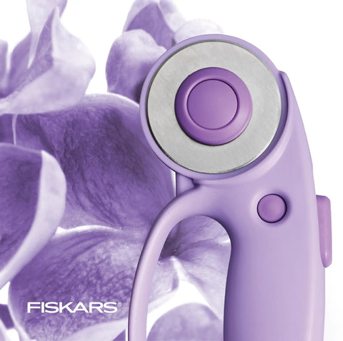 Top Tier Loop Handle Rotary Cutter For Heavy Duty Fabric And Vinyl Crafting Precision Ground Steel Blade Insanely Sharp close-up of purple handle