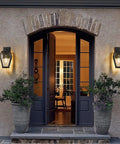 House entrance with two Heavy Duty Aluminum Outdoor Wall Light Fixture Built Tough With Waterproof Lanterns on either side of the door.