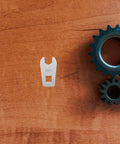 Slick Steel Hand Torque Wrench With Eight Millimeter Open End Jaw Portable Bike Gear on wooden surface next to gears.