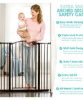 Woman holding baby next to an Extra Tall 36 Inch Baby Gate With Door, Pressure Mount For Doorways And Bottom Of Stairs, black color.