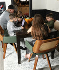 Family seated at a dining table with Set Of 2 Swivel Dining Chairs With Curved Arms, Ergonomic Cane Back, Bentwood Frame, in Walnut Beige.