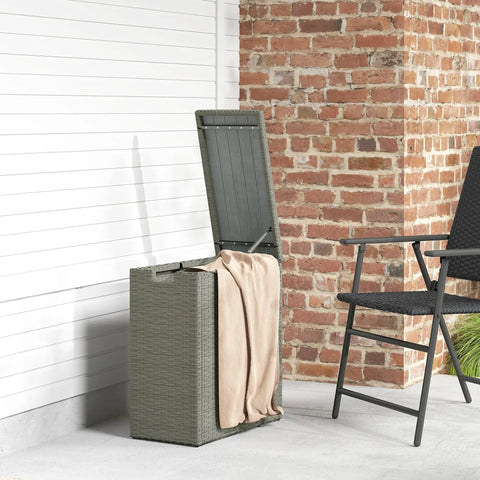Weatherproof 17.3 Gallon Wicker Storage Box With Slatted Acacia Wood Flip Top for indoor and outdoor use near a brick wall.