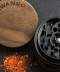 AWANSO 3-piece kitchen spice grinder, 2.5-inch walnut wood and aluminum, lid off to the side with ground red pepper.