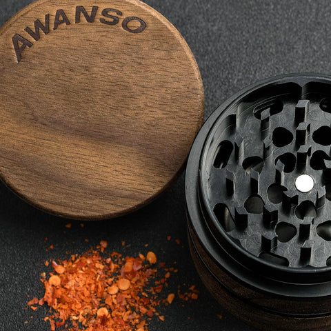 AWANSO 3-piece kitchen spice grinder, 2.5-inch walnut wood and aluminum, lid off to the side with ground red pepper.