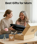 Two women joyfully unboxing a Full Body Massage Mat With Heat And Vibration 10 Motor Back Massage Pad for home use.