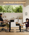 Rustic Brown Electric Standing Desk 48x24 Inches For Short People Adjustable Height 18.1 To 28.3 Inches with user seated and standing.