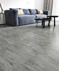 Grey Peel And Stick Floor Tiles 20 Pack, 12x12 Inch, Thick 1.5mm Wood Vinyl Flooring in living room setting with blue sofa.