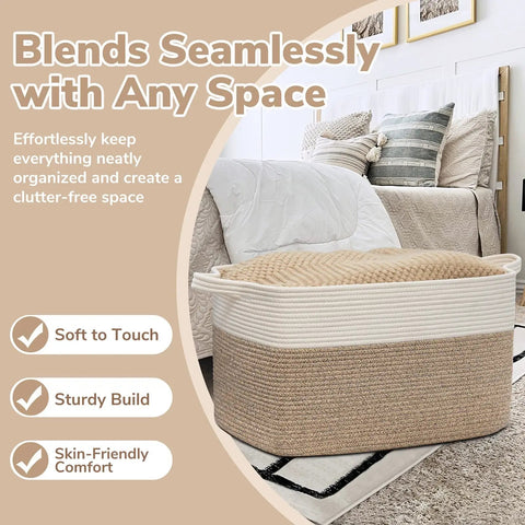 Oversized Woven Blanket Storage Basket, 21.6 Inch Long By 14.9 Inch Wide By 11.8 Inch High, 75L Capacity, White And Brown Cotton Rope Rectangle Toy Organizer for Living Room and Bedroom next to a bed.