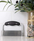 Stainless steel crinkle cutter with black ergonomic handle for vegetables
