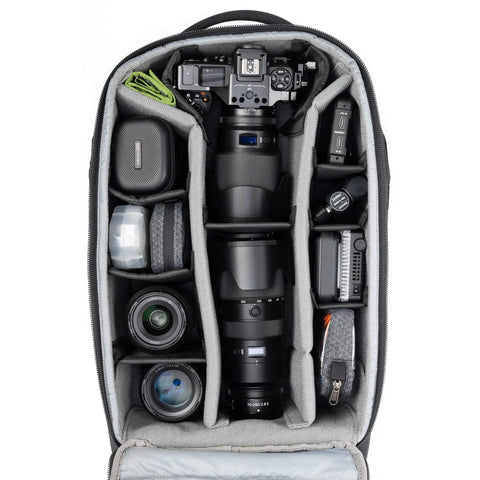 Interior of Walker Pro Rolling Camera Backpack with customizable compartments showing camera gear and lenses