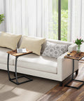 Set Of 2 C Shaped End Tables For Couch With Curved Legs Space Saving Under Sofa Side Tables, rustic brown finish next to a beige couch.