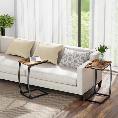 Set Of 2 C Shaped End Tables For Couch With Curved Legs Space Saving Under Sofa Side Tables, rustic brown finish next to a beige couch.