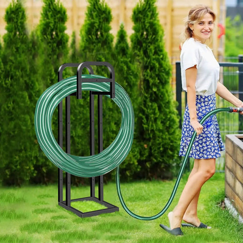 Heavy Duty Freestanding Garden Hose Holder With Upgraded 150 Ft Capacity Metal Hose Stand in yard with woman using hose