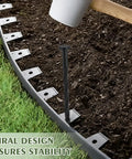 Heavy Duty Landscape Spikes 8 Inch Pack Of 100 For Weed Barrier And Paver Edging being hammered into ground with mallet