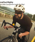 Cyclist riding road bike with Night Glow Alien Strap On Bike Ornament Silicone Decoration on handlebars, waterproof