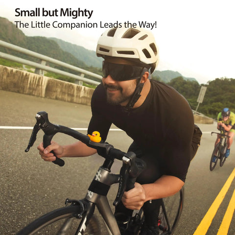 Cyclist riding road bike with Night Glow Alien Strap On Bike Ornament Silicone Decoration on handlebars, waterproof