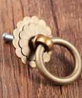 Vintage Style Brass Ring Pulls For Cabinets And Drawers, Round Cabinet Knobs and Drawer Handles on wood surface.