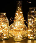 4 Pack 16.4 Feet 50 LED Fairy Lights Battery Operated With Remote Timer Waterproof Copper Wire Twinkle String Lights glowing inside glass vases