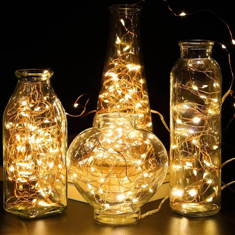 4 Pack 16.4 Feet 50 LED Fairy Lights Battery Operated With Remote Timer Waterproof Copper Wire Twinkle String Lights glowing inside glass vases