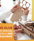 Person assembling Groovy Retro Wooden 3D Puzzle Featuring Killer Rubber Band Powered Mechanical Model Car Kit With Working V8 Engine Pistons Openable Doors And Sick Diy Craft Build For Adults without glue.