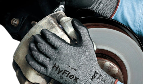 Close-up of HyFlex 11-801 Nylon Glove With Black Foam Nitrile Coating and Knit Wrist Cuff in use on automotive part