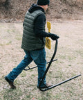 Person carrying AR500 Dual Spinner Target for rifle shooting, collapsible stand for easy transport, three eighths inch steel target
