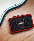Mini 5W Electric Guitar Practice Amp With Clean And Overdrive Modes, Bluetooth Streaming, Headphone Jack, red amp on floor