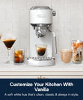 Compact Espresso And Cold Brew Coffee Maker Featuring Built In Milk Frother Wand for making hot and iced coffee drinks on a counter.