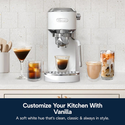 Compact Espresso And Cold Brew Coffee Maker Featuring Built In Milk Frother Wand for making hot and iced coffee drinks on a counter.
