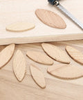 Beech Wood Joiner Biscuits 45x16x3.8mm Pack Of 50 For Woodworking Joinery And Pros And DIYers shown with a saw on wooden surface