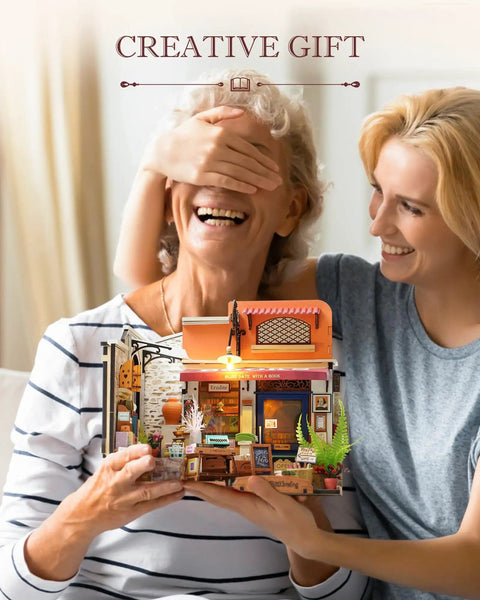 Two people smiling with DIY Miniature Bookstore Kit 1 To 20 Scale With LED Lights Build Your Own Tiny House Craft Kit