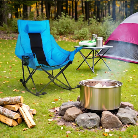 Oversized Rocking Camping Chair With Luxury Padded Recliner For All Day Comfort Heavy Duty Folding Lawn Chair in blue by a campfire.