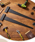 Two Pack Oversized 26 And A Quarter Inch Heavy Duty Black T Shaped Door Hinges With Screws Rustic Flush Mount For Sheds Barns Garden Gates And Garage Doors, surrounded by tools on a wooden surface.