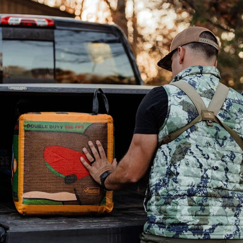 Person loading Four Sided Archery Target Bag For Backyard Practice And Outdoor Training Double Duty Field Point Target into truck