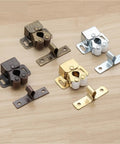 Assorted magnetic cabinet catches and door stops pack with slick closers and damper buffers in different finishes on a wooden surface.