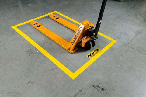 Heavy Duty Polyester Floor Marking Tape In Bright Yellow With Kick Ass Adhesion For Concrete Warehouses And 2 Inch By 100 Foot Roll marking a pallet jack spot on a warehouse floor.