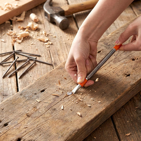 Using 4 Piece Dual Head Nail Setter And Center Punch Kit With Hammerless Cold Chisel on wooden plank