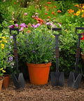 Four Piece 27 Inch Curved D Handle Shovel Set For Gardening And Digging, three mini spades in a colorful garden, 27-inch size visible